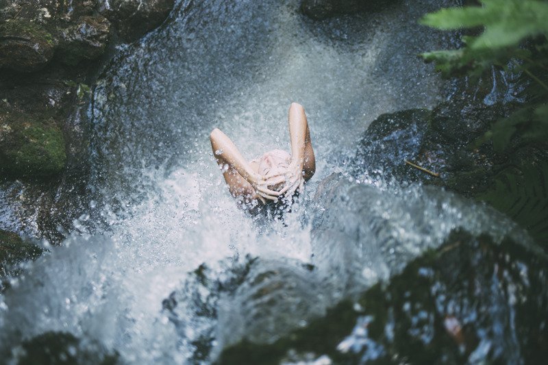 canva-a-woman-showering-at-the-waterfall-MADQ4_WC3A4 (1)